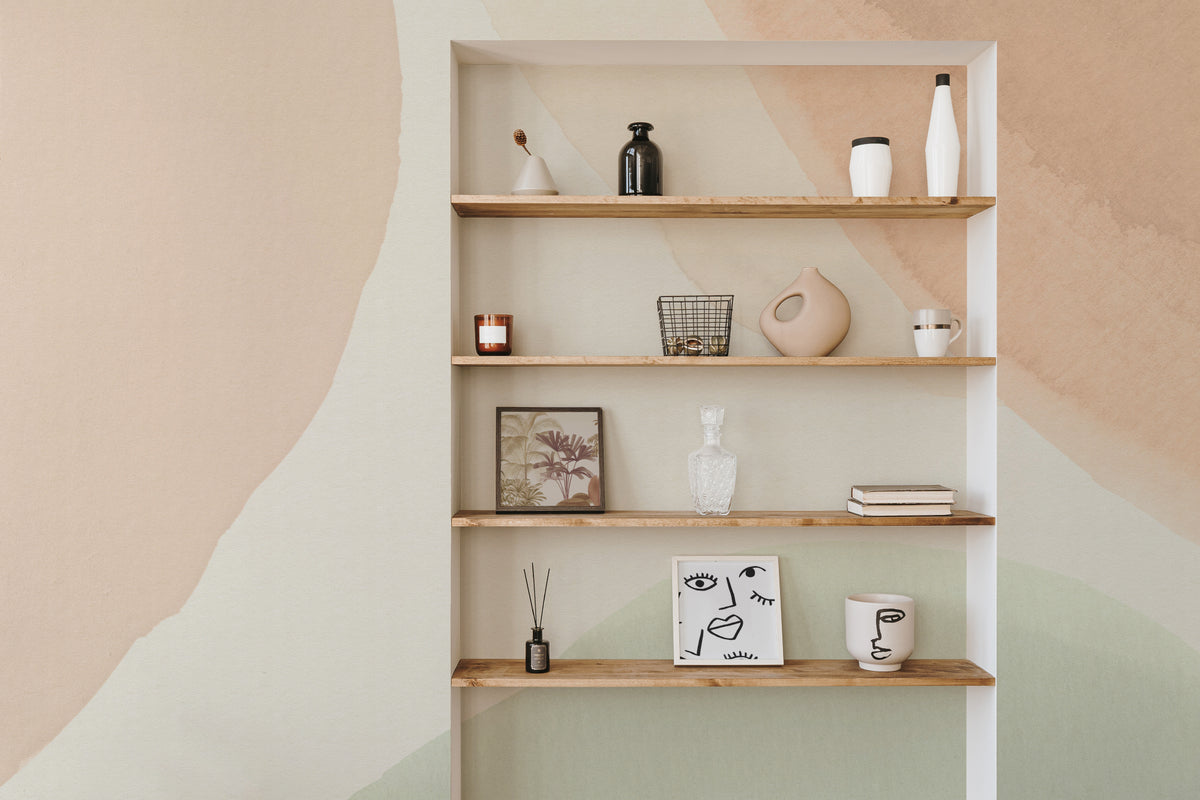 The Pebble Wash mural in peach and sage as a backdrop to styled furniture