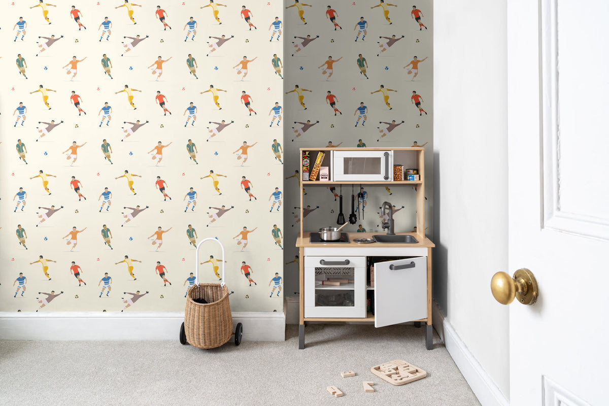 The Pitchside Club wallpaper in warm cream behind a kids' play corner