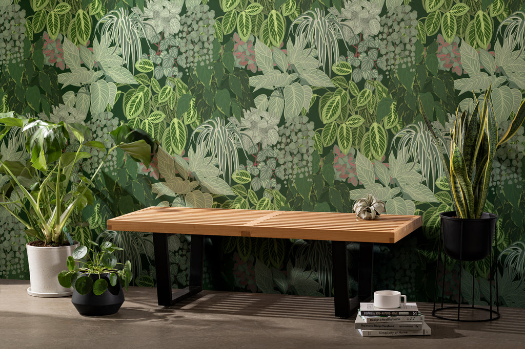 The Plant Room wallpaper in deep green as a backdrop to styled furniture