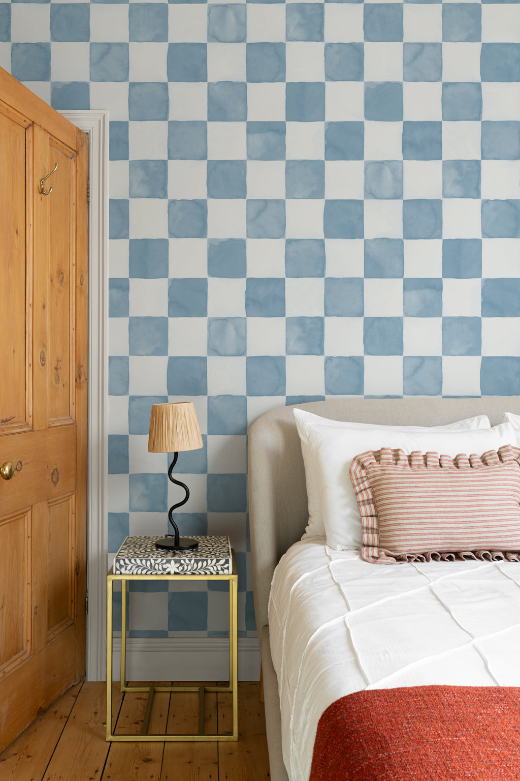 The Poolside Check mural in pool blue behind a styled console