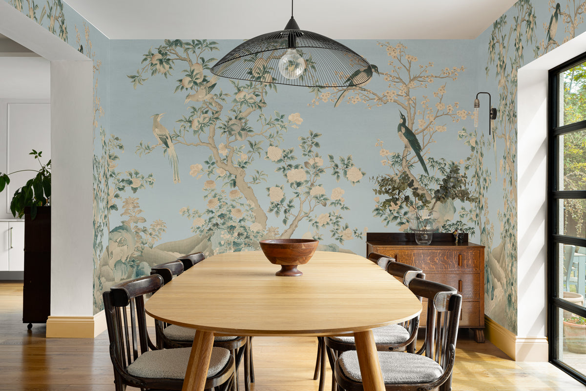 The Porcelain Screen mural in duck egg and stone behind a dining table