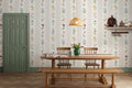 The Posy Braid mural in blush pink behind a dining table