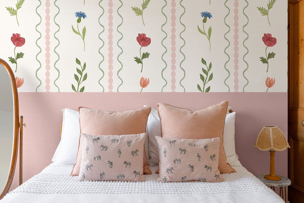 The Posy Braid mural in blush pink behind the bed in a bedroom