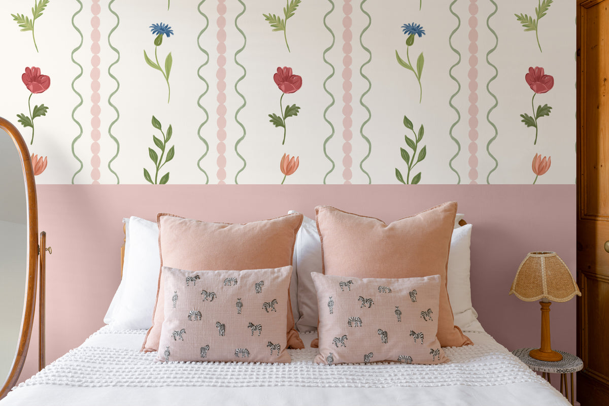 The Posy Braid mural in blush pink behind the bed in a bedroom