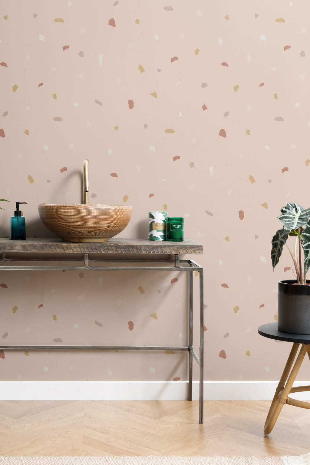 The Quarry Fleck wallpaper in rosy beige behind a styled console