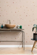 The Quarry Fleck wallpaper in rosy beige behind a styled console