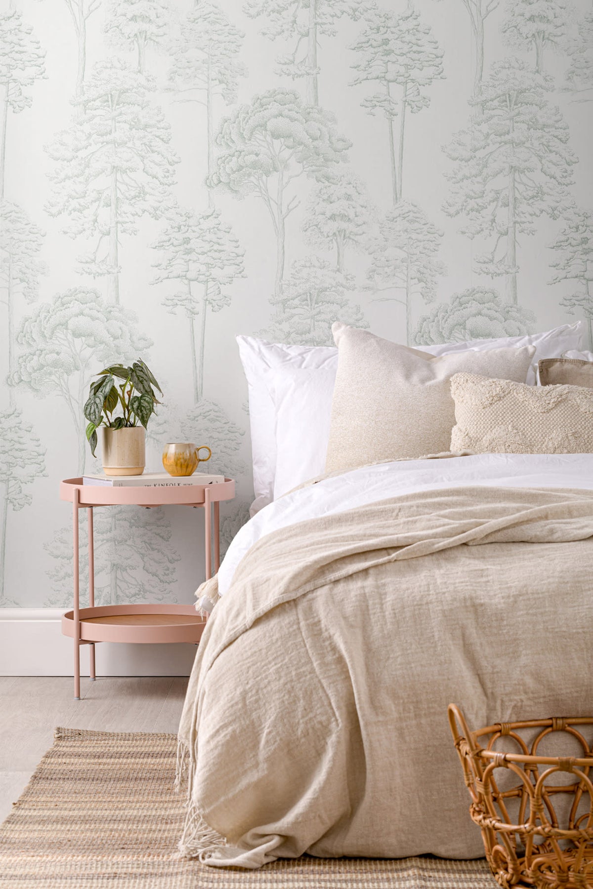 The Quiet Arboretum wallpaper in pale sage behind the bed in a bedroom