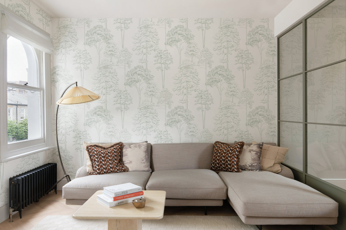 The Quiet Arboretum wallpaper in pale sage in a living room