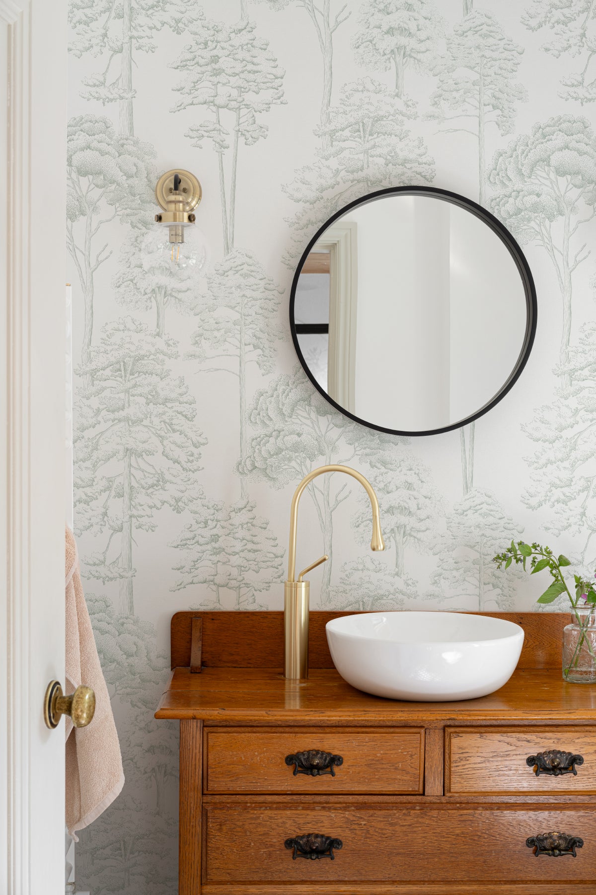 The Quiet Arboretum wallpaper in pale sage in a styled room setting