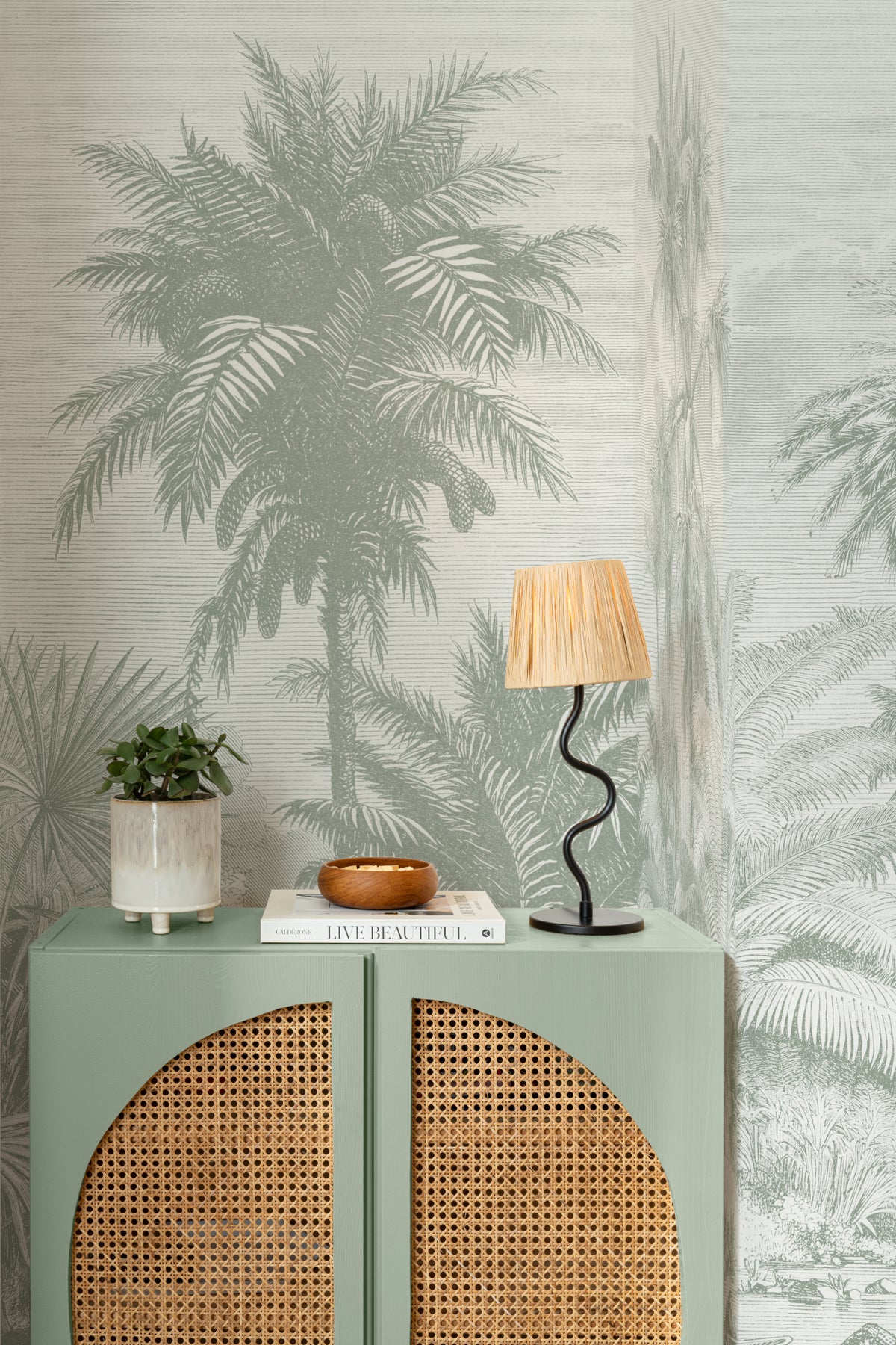 The Rainforest Etching mural in sage and stone behind a styled console