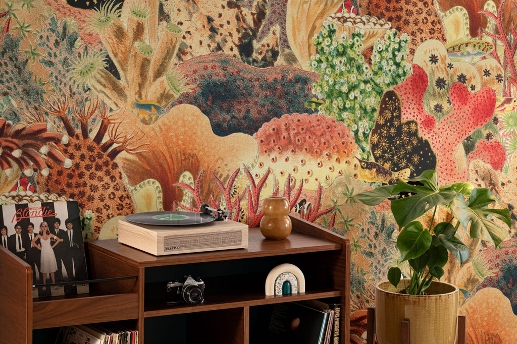 The Reef Cabinet mural in coral red and jade behind a desk in a home office