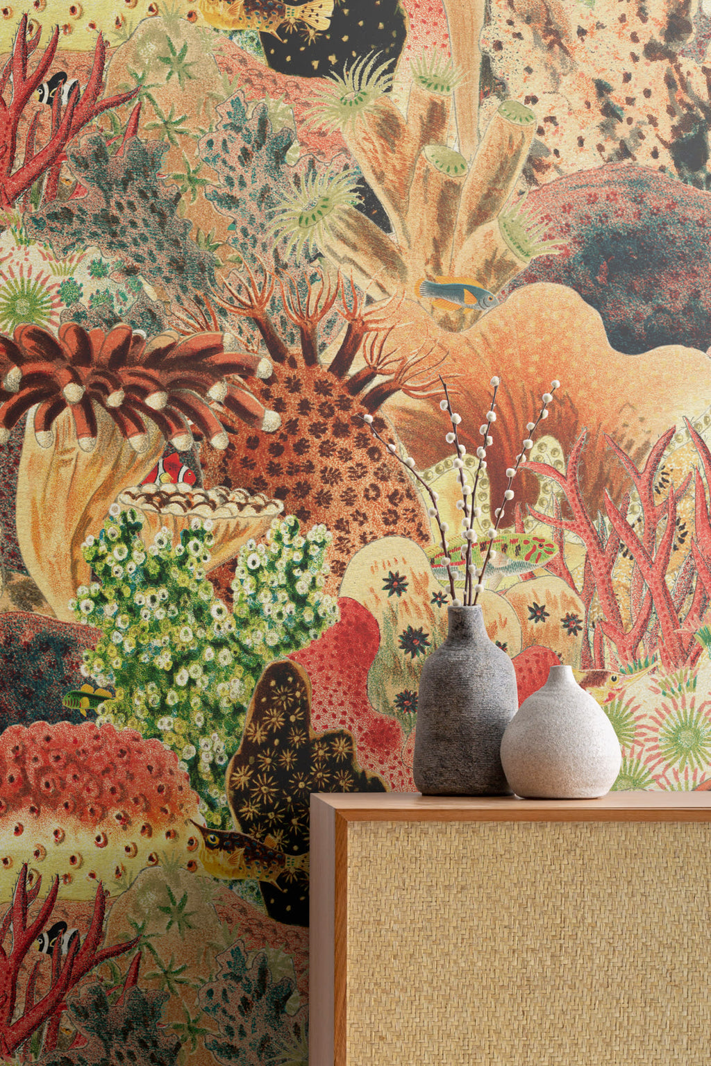 The Reef Cabinet mural in coral red and jade as a backdrop to styled furniture