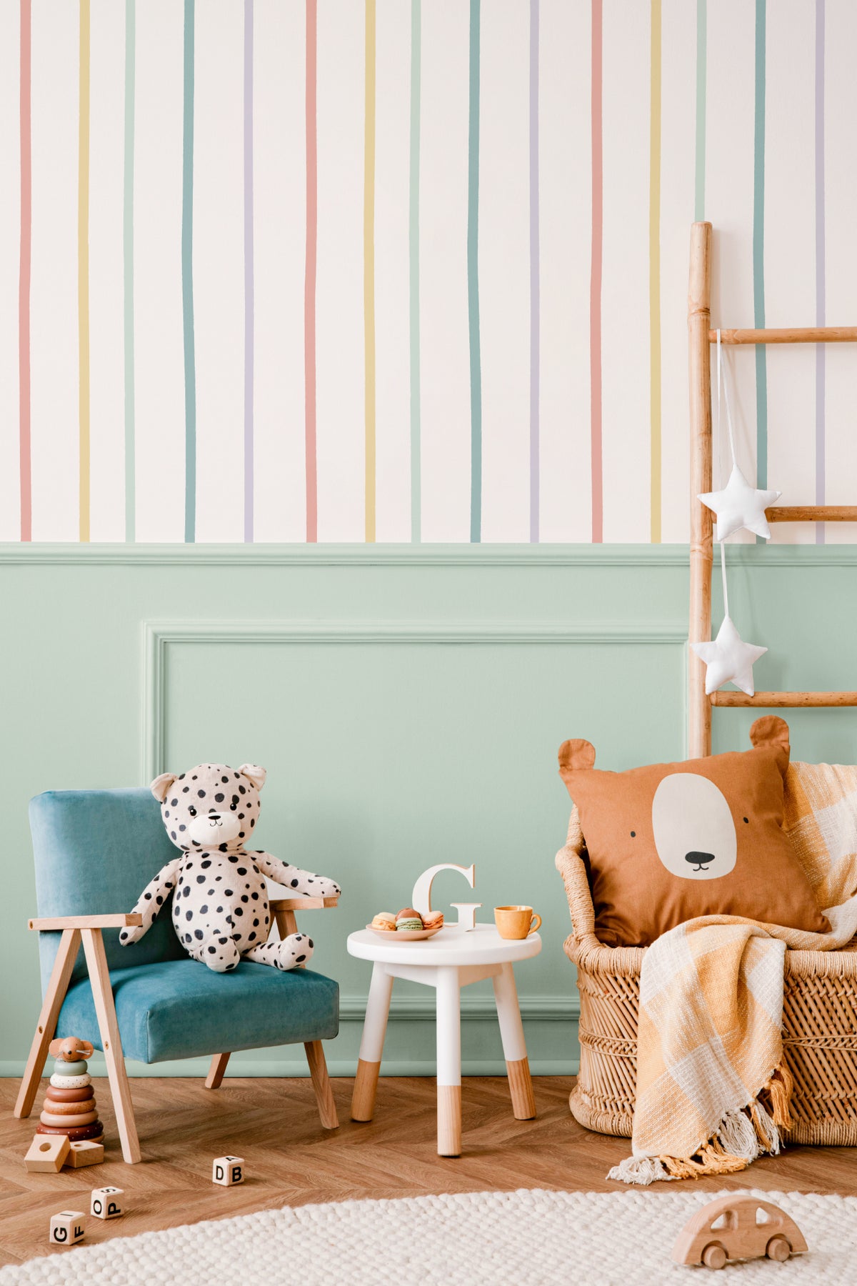 The Ribbon Lane wallpaper in sorbet pastel behind a kids' play corner