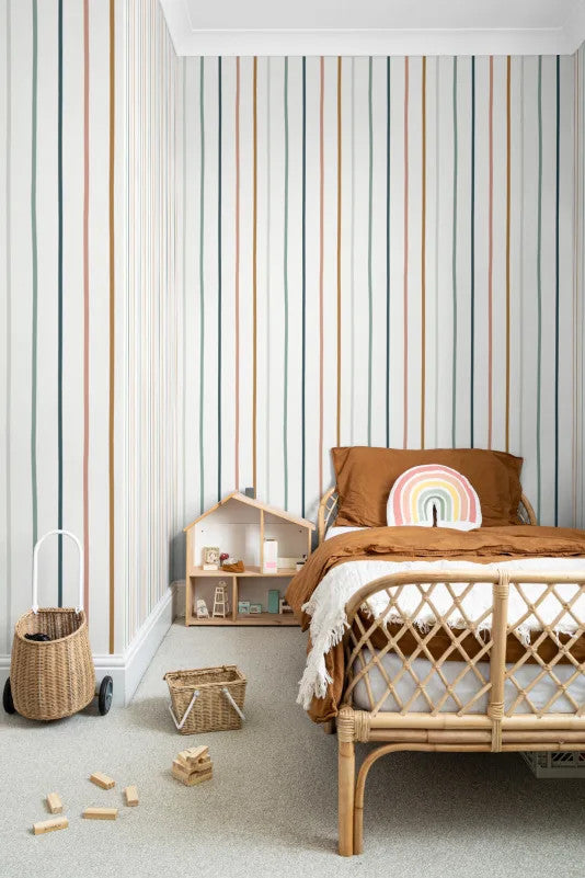 The Ribbon Lane wallpaper in spice and teal behind a kids' play corner