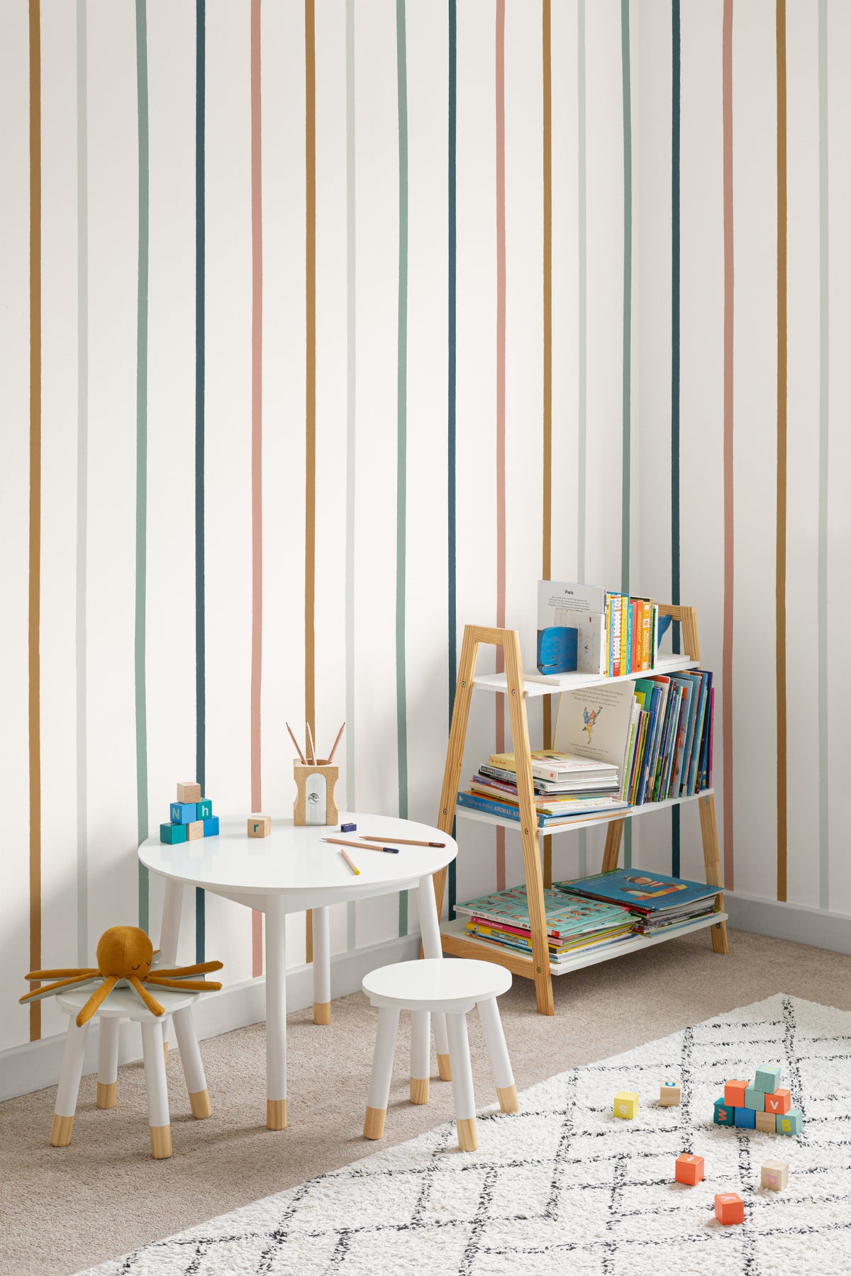 The Ribbon Lane wallpaper in spice and teal in a children's room setting, another angle