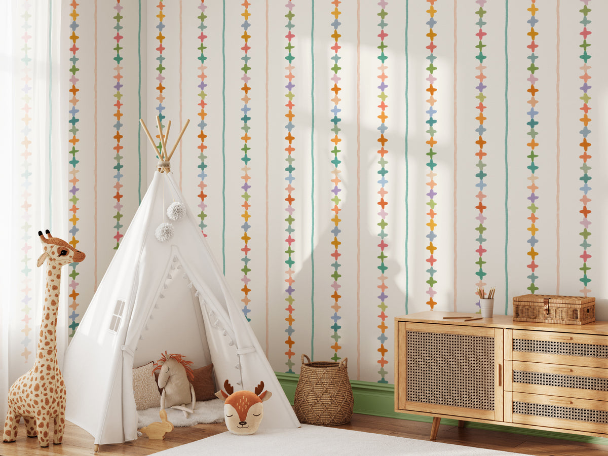 The Ribbon Maypole wallpaper in sage and sherbet in a child's bedroom