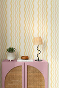 The Ripple Trim wallpaper in buttercup yellow behind a styled console