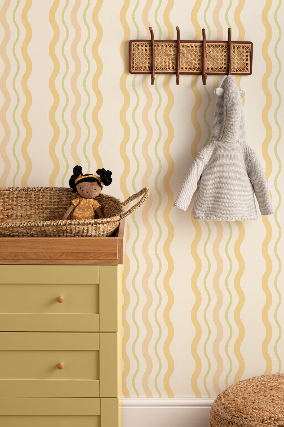 The Ripple Trim wallpaper in buttercup yellow on a nursery wall