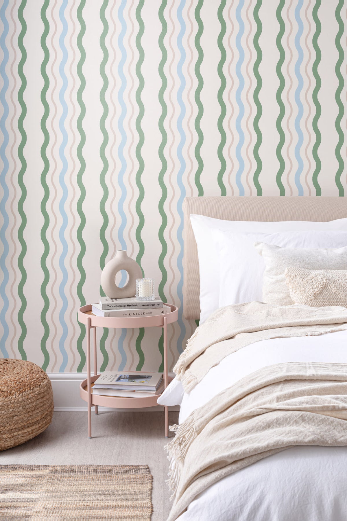 The Ripple Trim wallpaper in sage and sky behind the bed in a bedroom