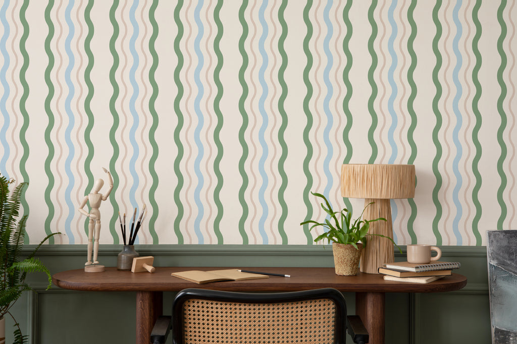 The Ripple Trim wallpaper in sage and sky as a backdrop to styled furniture