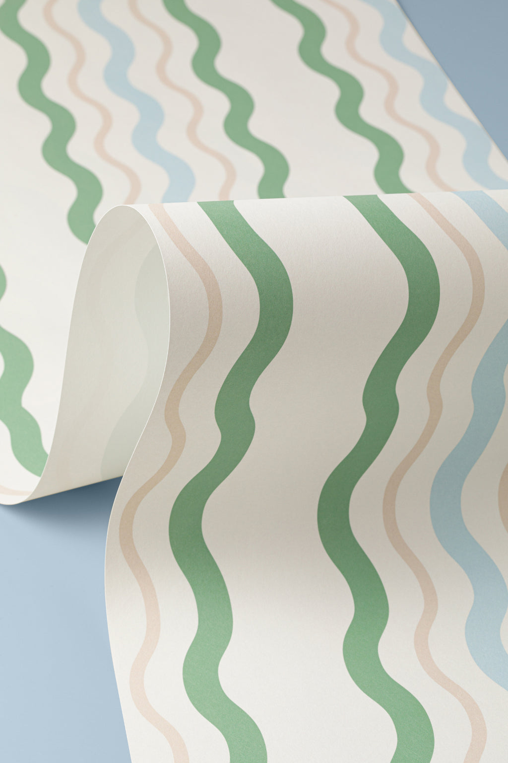 Angled detail of The Ripple Trim wallpaper in sage and sky
