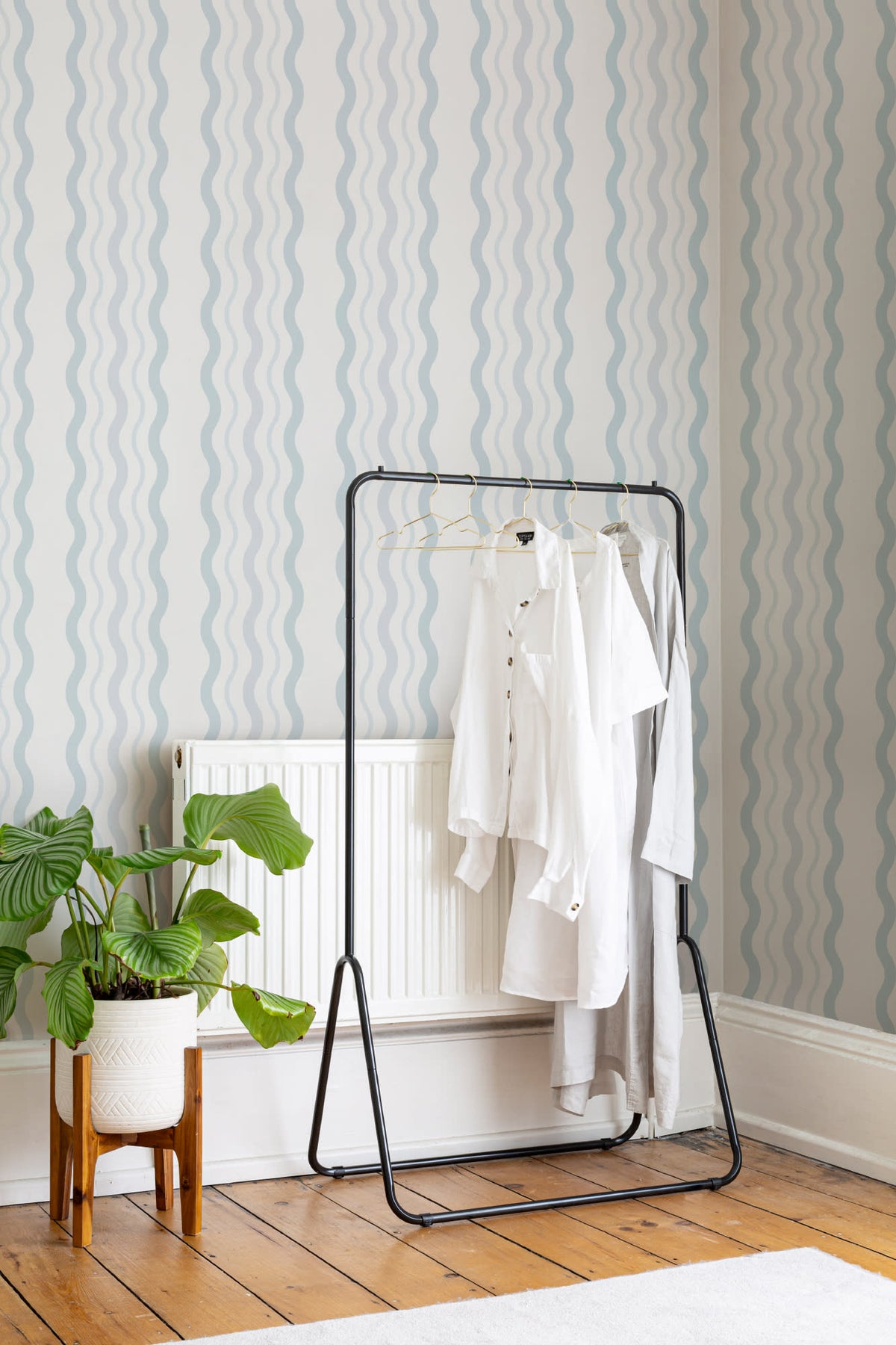 The Ripple Trim wallpaper in sky blue in a hallway
