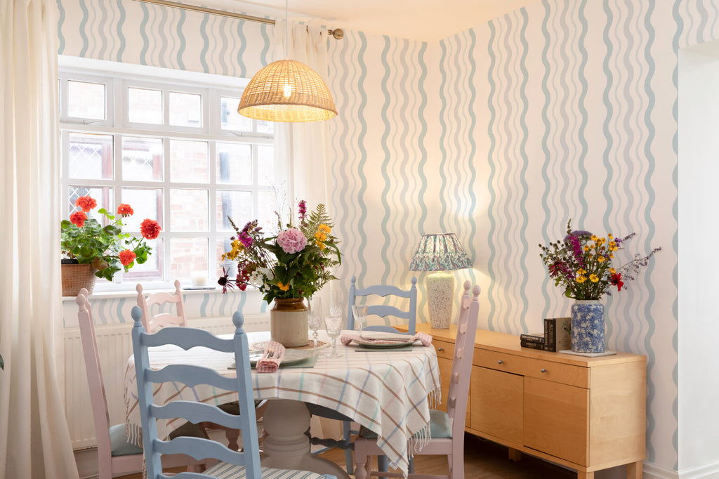 The Ripple Trim wallpaper in sky blue on a nursery wall