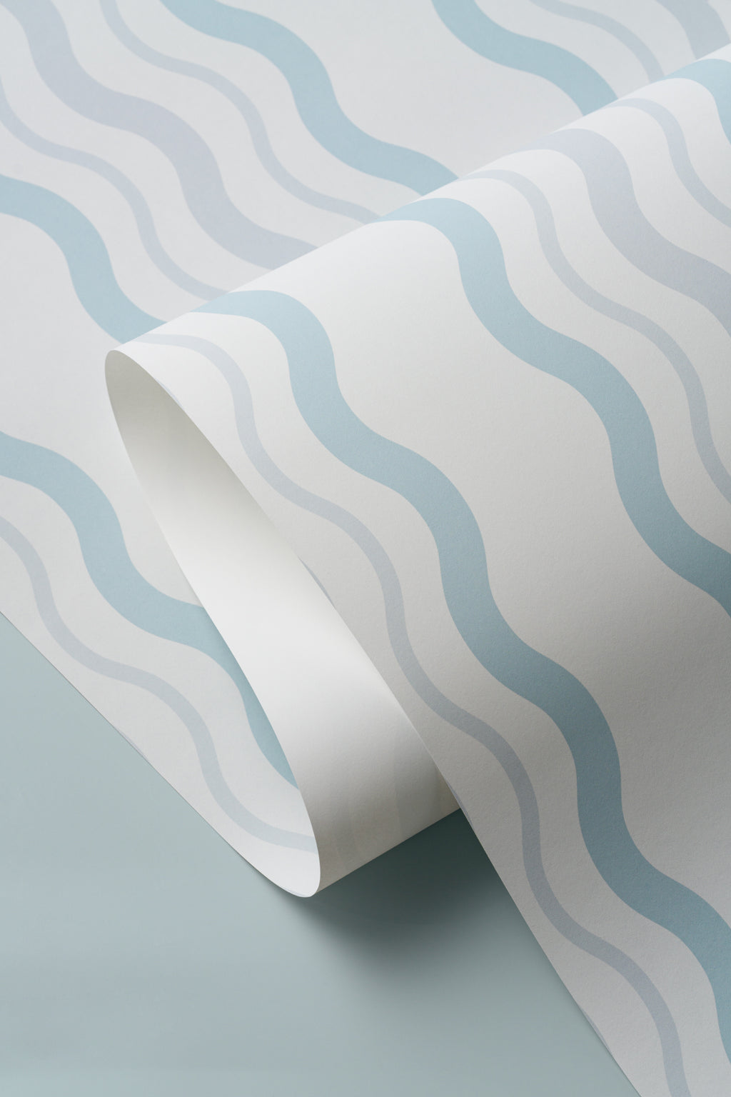 Angled detail of The Ripple Trim wallpaper in sky blue