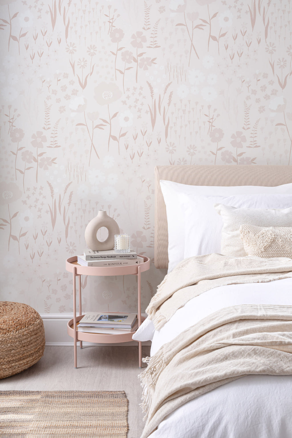 The Rosehip Field wallpaper in dusky pink behind the bed in a bedroom