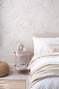 The Rosehip Field wallpaper in dusky pink behind the bed in a bedroom