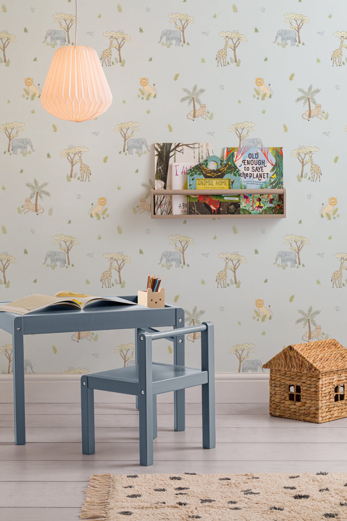 The Savanna Parade wallpaper in powder blue on a nursery wall