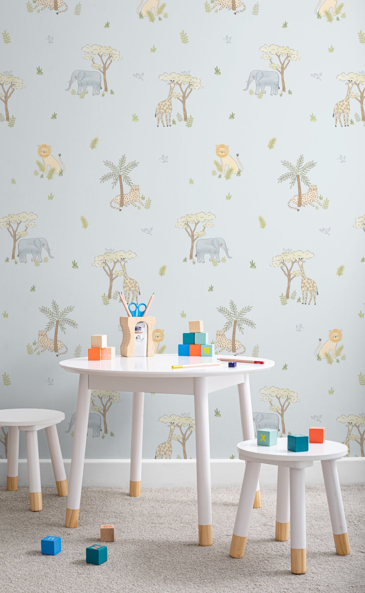 The Savanna Parade wallpaper in powder blue behind a kids' play corner