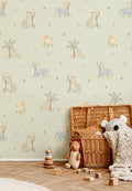 The Savanna Parade wallpaper in soft sage on a nursery wall