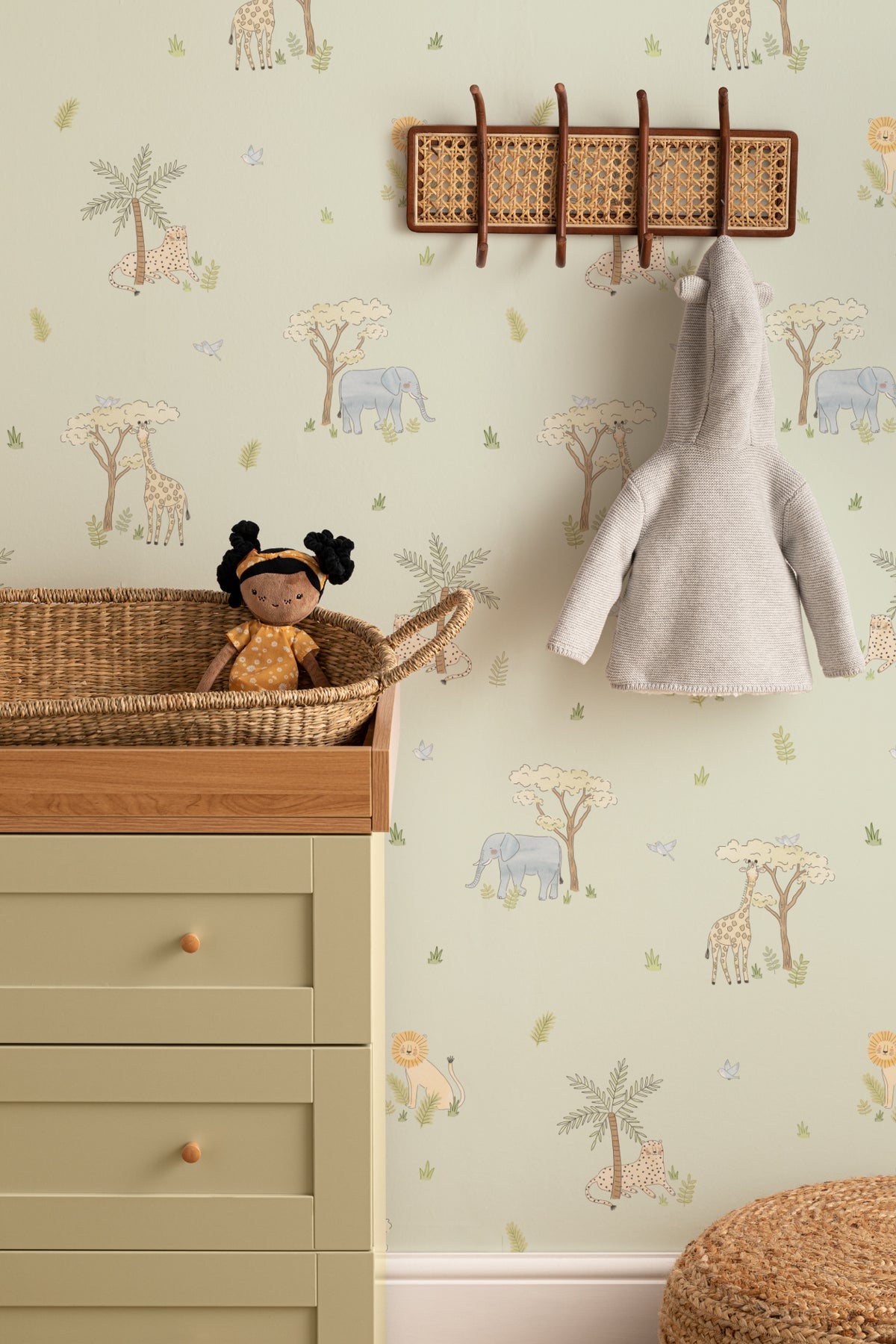The Savanna Parade wallpaper in soft sage behind a kids' play corner