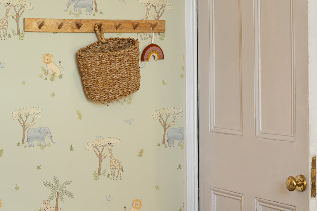 The Savanna Parade wallpaper in soft sage in a hallway