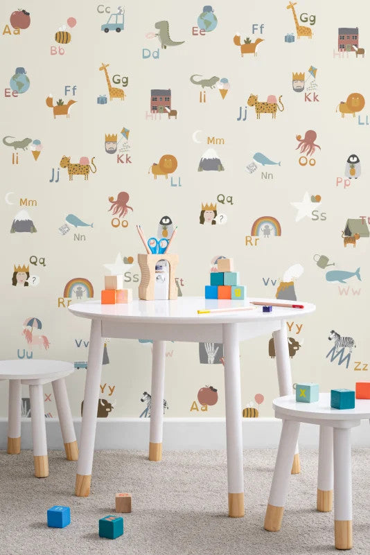 The Schoolroom Primer wallpaper in oatmeal and pastel behind a kids' play corner