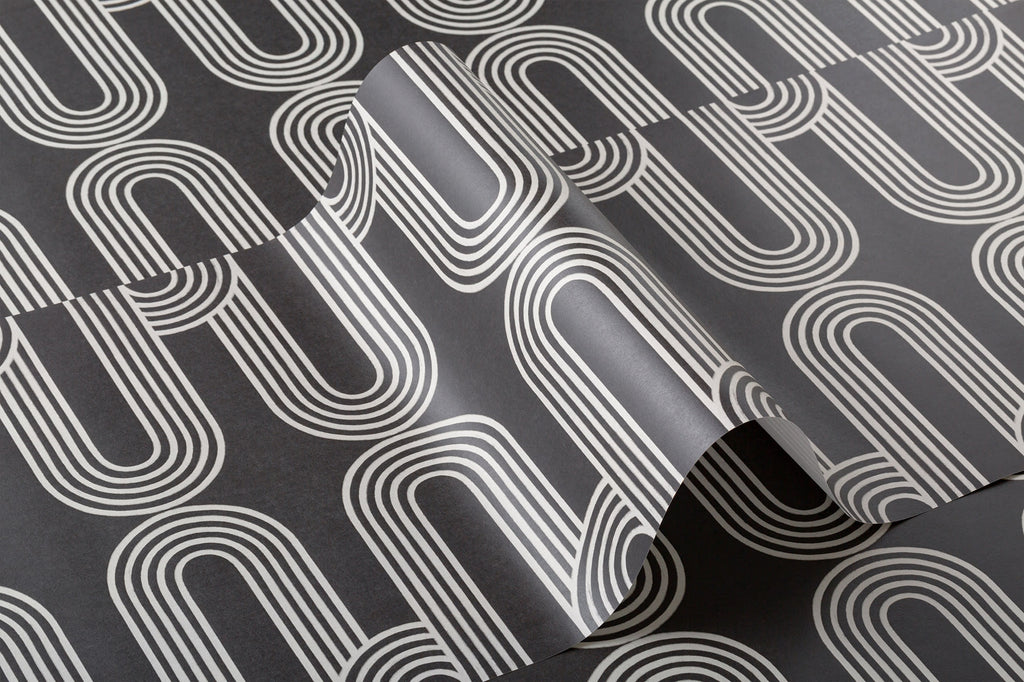 Angled detail of The Serpentine Line wallpaper in ink black and white