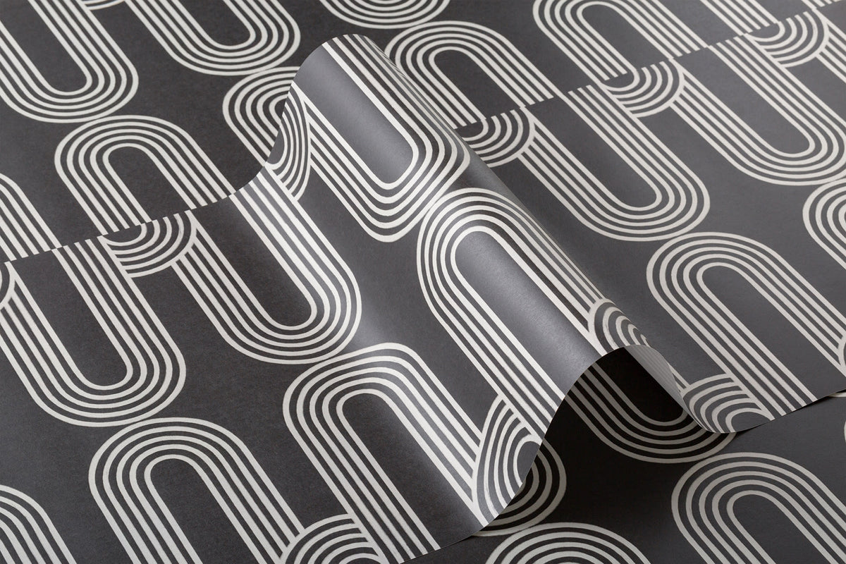 Angled detail of The Serpentine Line wallpaper in ink black and white