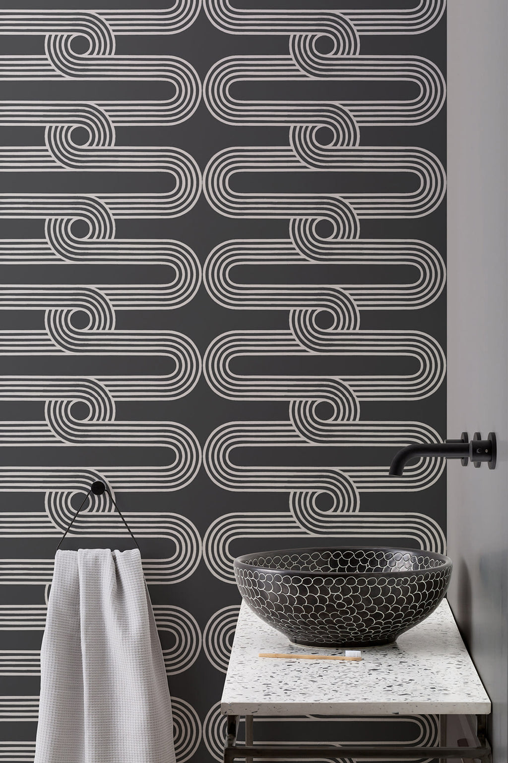 The Serpentine Line wallpaper in ink black and white in a bathroom