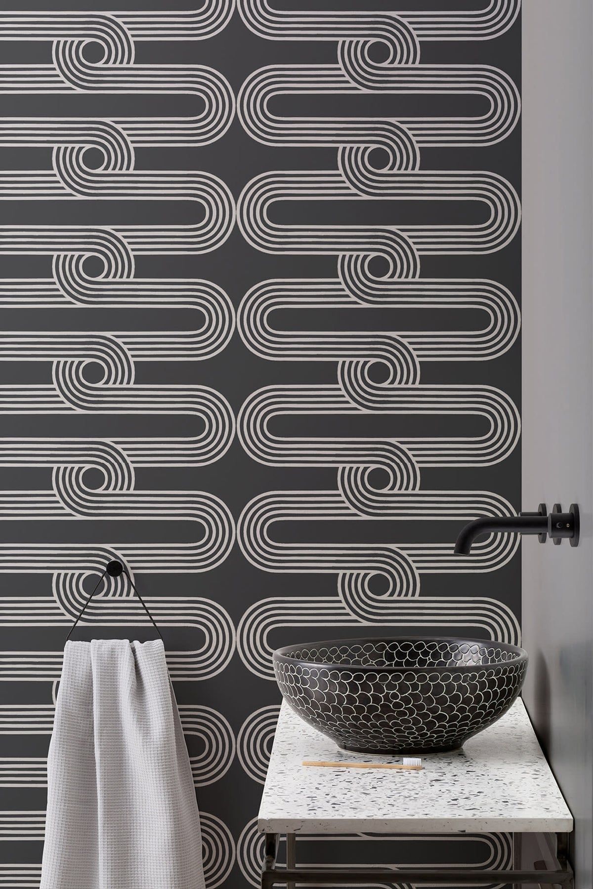 The Serpentine Line wallpaper in ink black and white in a bathroom
