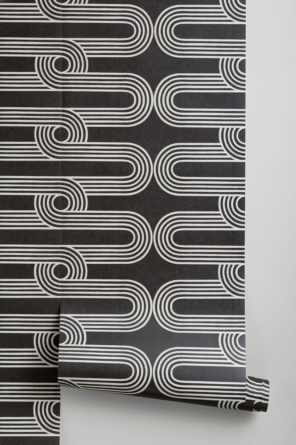 The Serpentine Line wallpaper in ink black and white behind a styled console