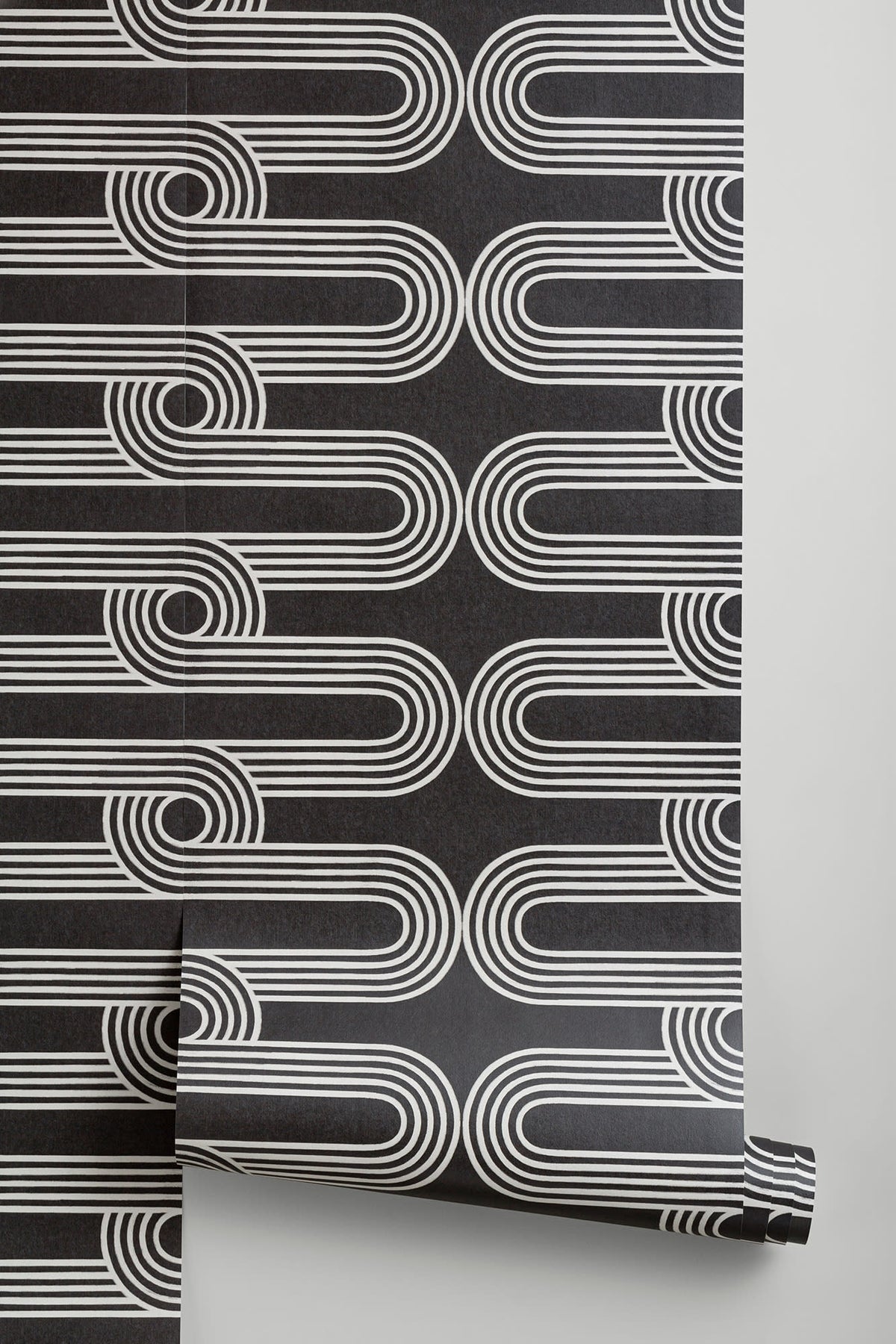 The Serpentine Line wallpaper in ink black and white behind a styled console
