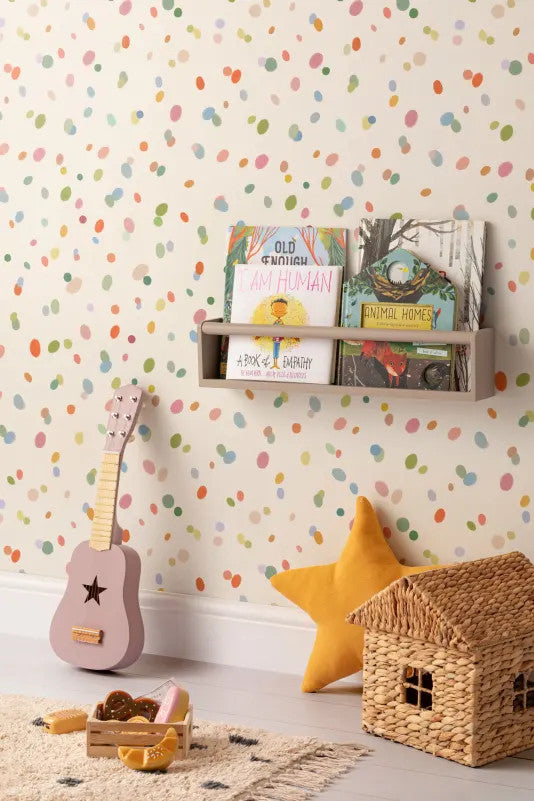 The Sherbet Confetti wallpaper in pastel multi behind a kids' play corner