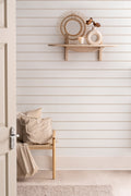 The Shoreline Stripe wallpaper in soft sand in a hallway