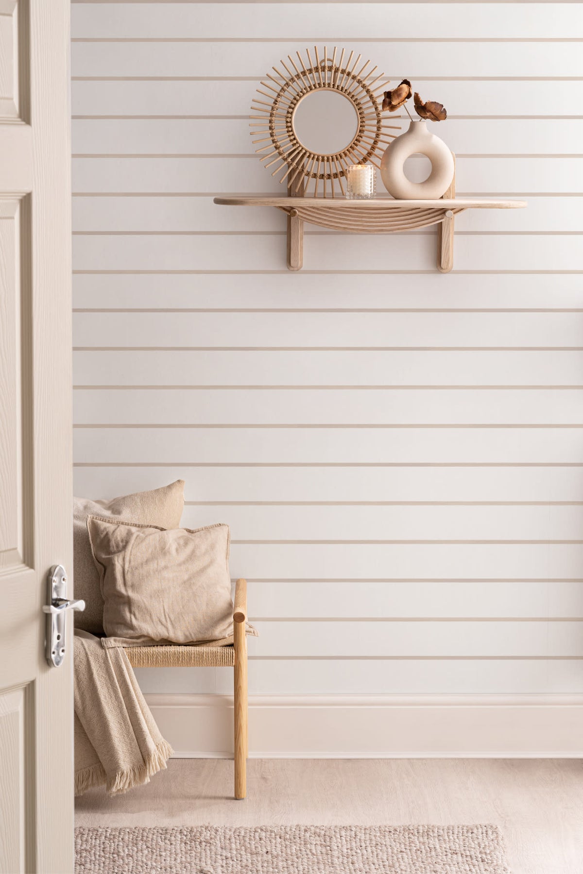 The Shoreline Stripe wallpaper in soft sand in a hallway