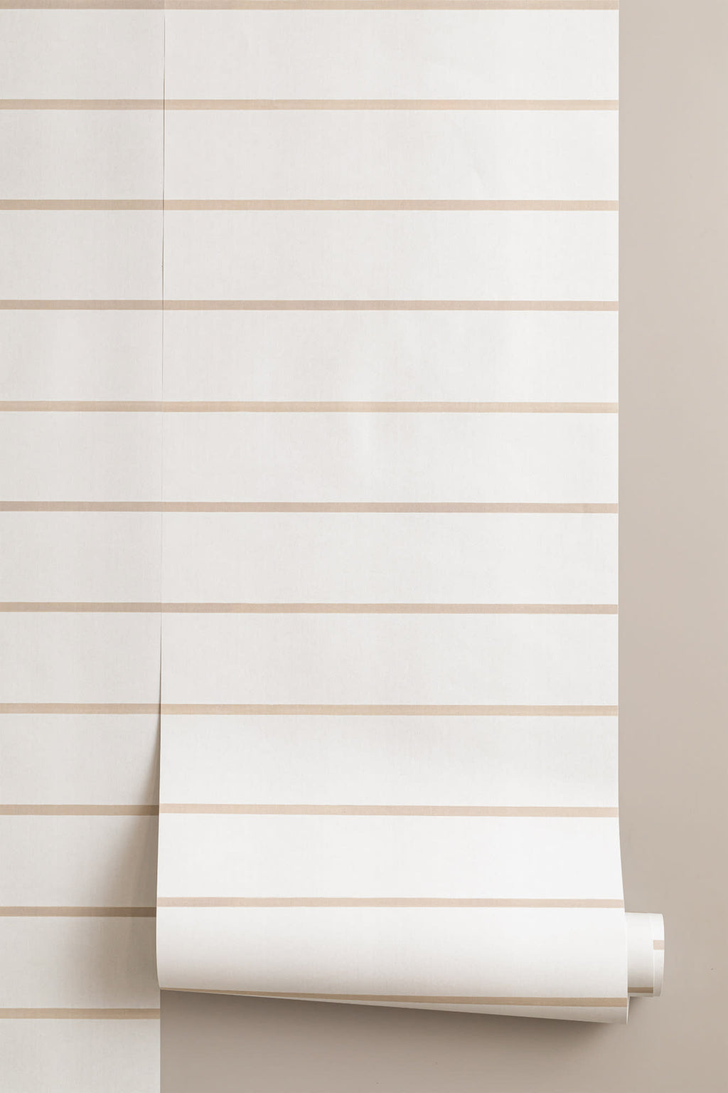 Roll of The Shoreline Stripe wallpaper in soft sand, another angle