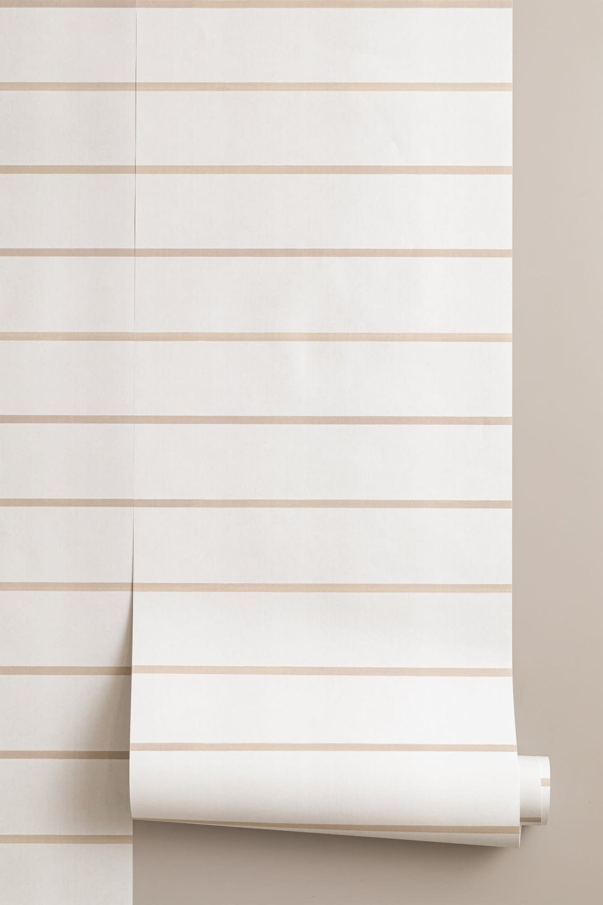 Roll of The Shoreline Stripe wallpaper in soft sand, another angle