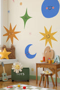 The Smiling Cosmos mural in sunshine and cobalt on a nursery wall