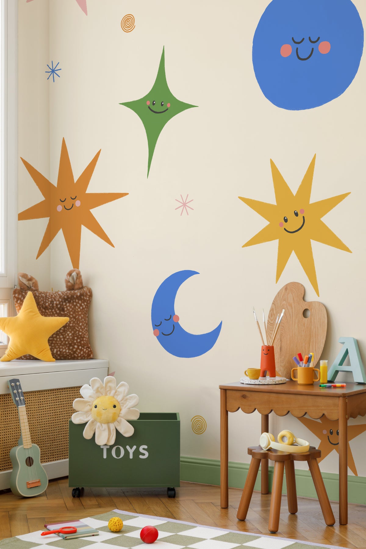 The Smiling Cosmos mural in sunshine and cobalt on a nursery wall
