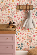 The Songbird Parterre wallpaper in blush and coral on a nursery wall